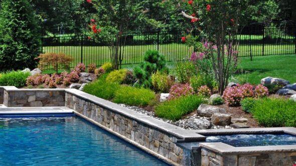 In ground pool with waterfall and natural stone
