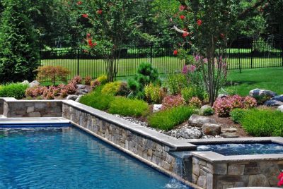 In ground pool with waterfall and natural stone