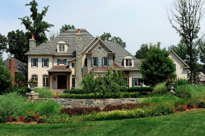 Front of house with lush greenery