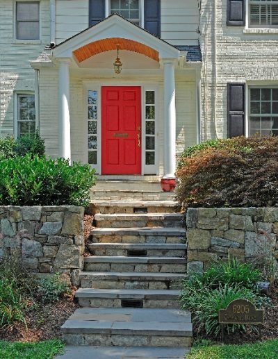 Stone stairs and retaining wall in front of house
