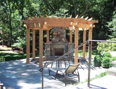 Stone patio with pergola and built in fireplace