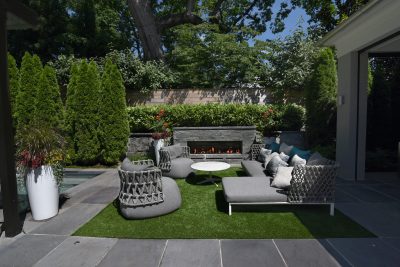 Blade hand-chiseled stone fireplace. Horizontal board fence.